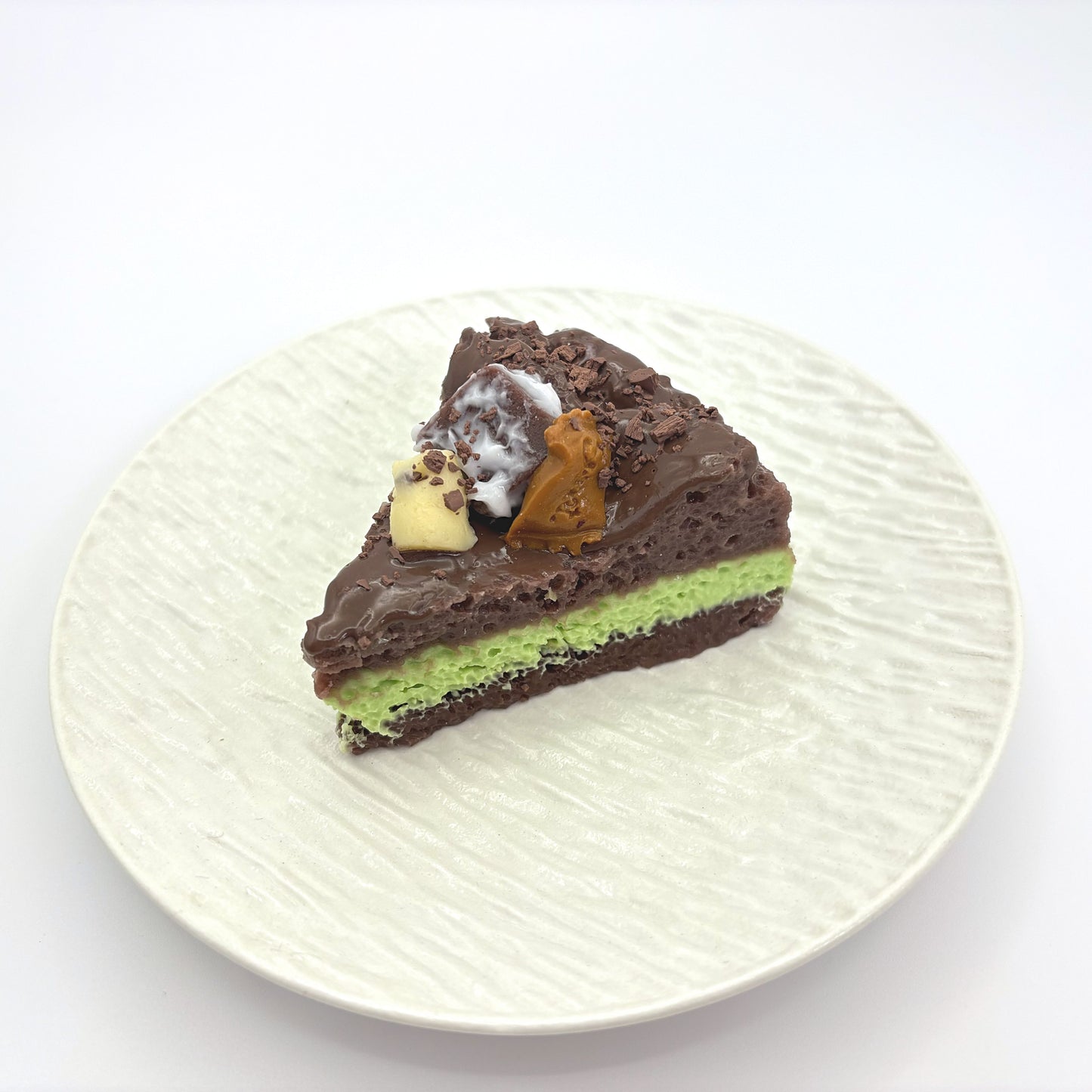 Front view of Lalachill’s Avocado  chocolate Cake Squishy, featuring a realistic avocado and raspberry cake design in soft silicone