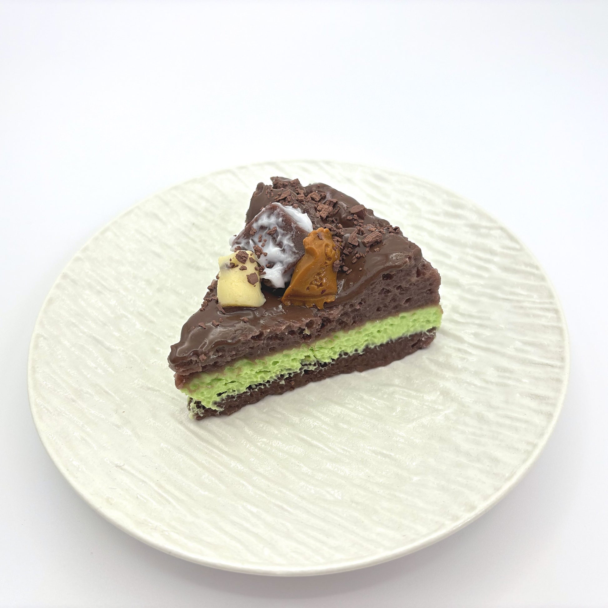 Front view of Lalachill’s Avocado  chocolate Cake Squishy, featuring a realistic avocado and raspberry cake design in soft silicone