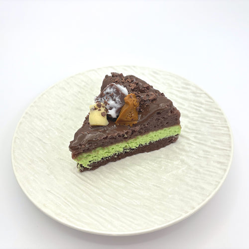 Front view of Lalachill’s Avocado  chocolate Cake Squishy, featuring a realistic avocado and raspberry cake design in soft silicone