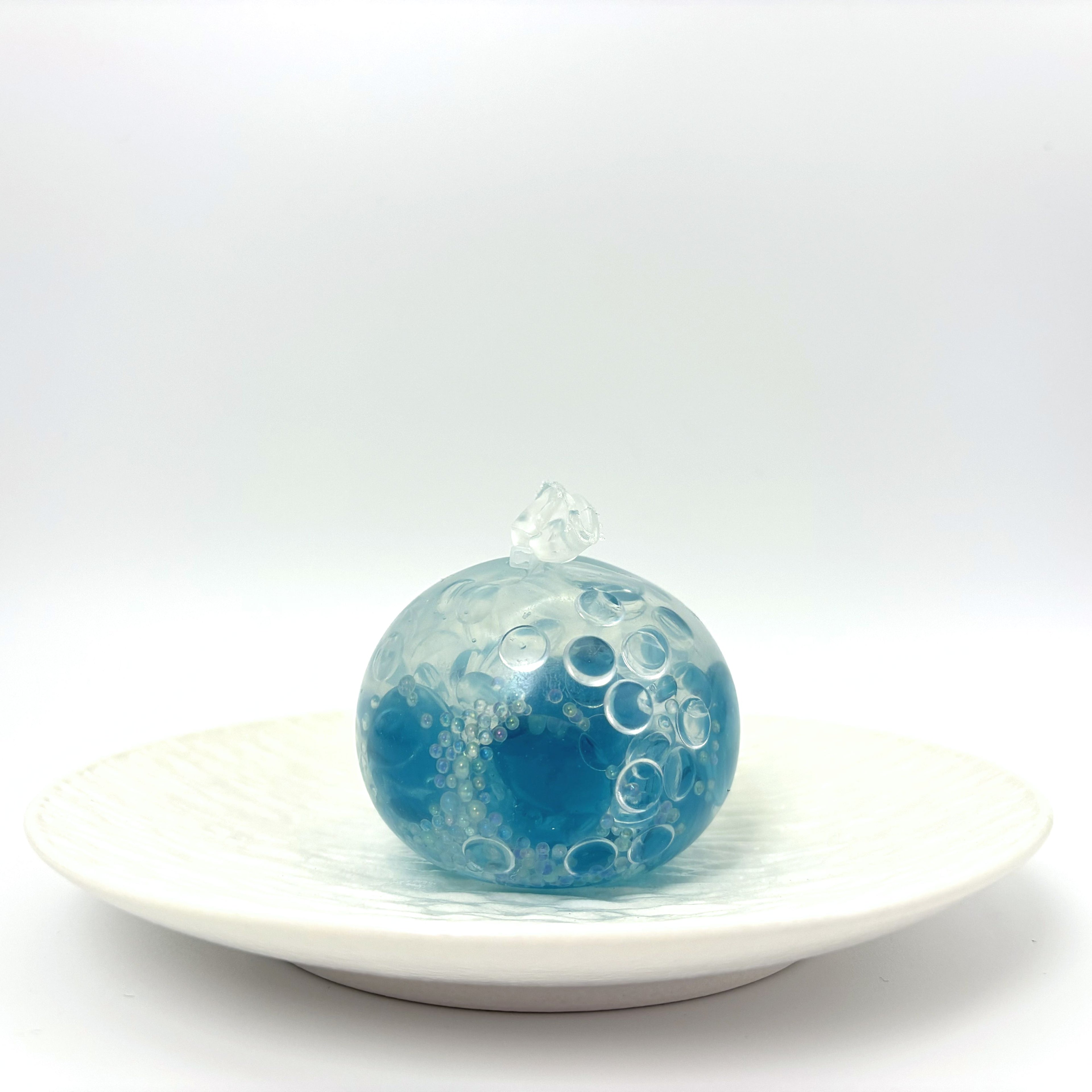 Lalachill Ocean Breeze stress ball in translucent blue with wave-like texture