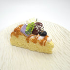 Closeup view of Lalachill’s Cheese Cherry Cake Squishy, showcasing its vibrant colors and realistic.