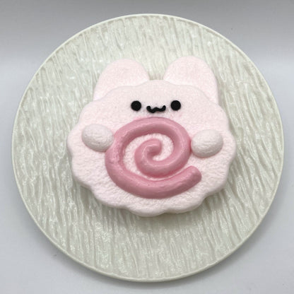 Top view of the Bunny Fish Cake Taba Squishy, featuring the playful bunny design and soft pink color