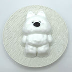 Top-down shot of the Cloud Pup taba squishy, capturing its fluffy texture and cute puppy features from above