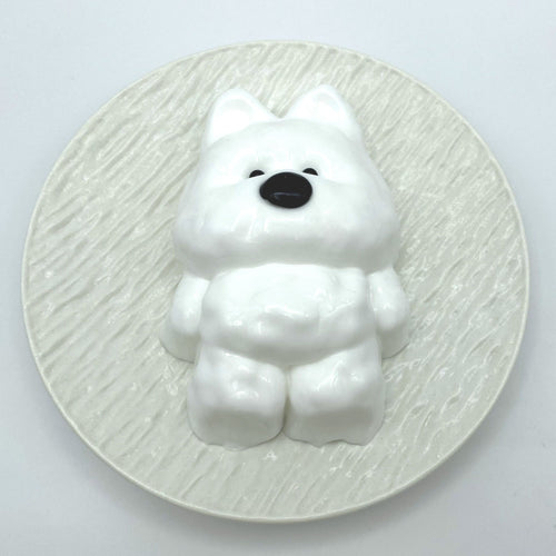 Top-down shot of the Cloud Pup taba squishy, capturing its fluffy texture and cute puppy features from above