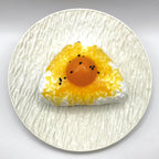 Top view of the Egg Yolk Rice Ball Taba Squishy highlighting the rice ball shape and bright yolk color