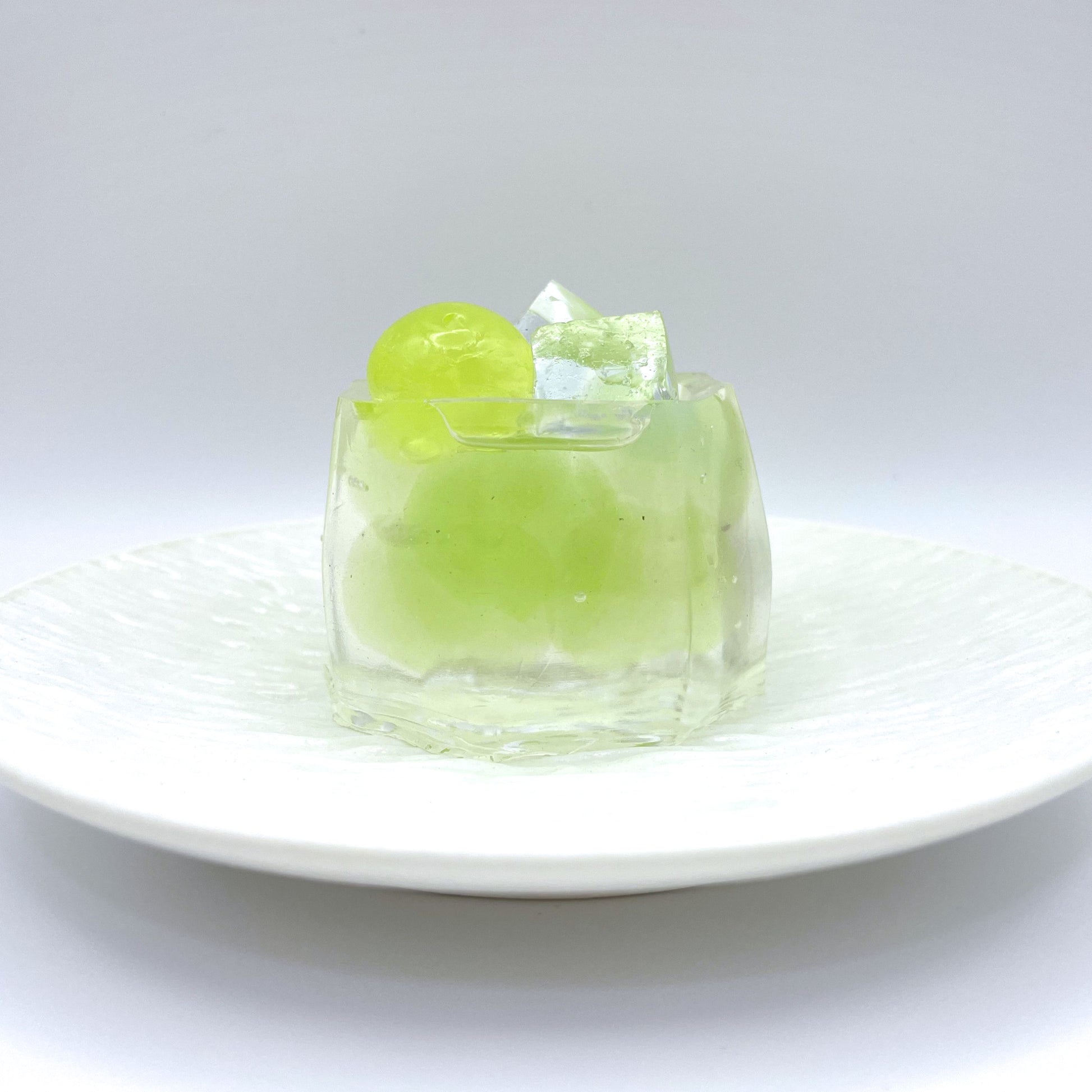 Front view of Green Grape Jelly Taba Squishy, featuring translucent outer layer and green grape detail